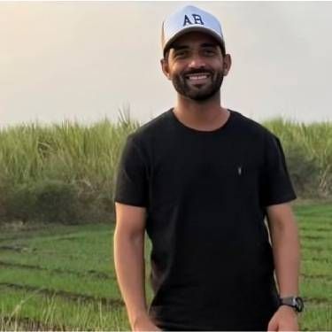 Man smiling and looking at the camera.