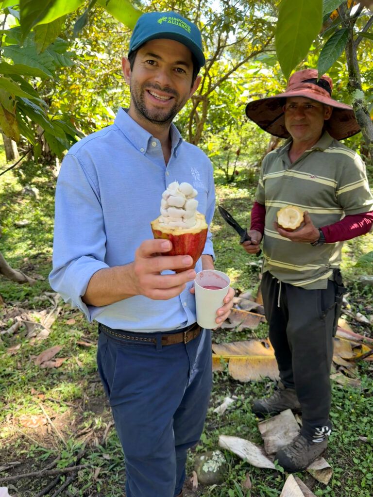 Man smiles while holding an open coffee pod